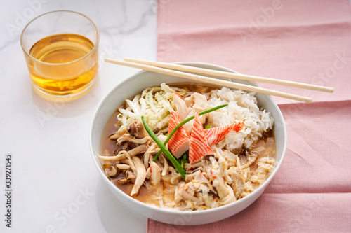 Asian-style bowl with mushrooms, rice and surimi photo