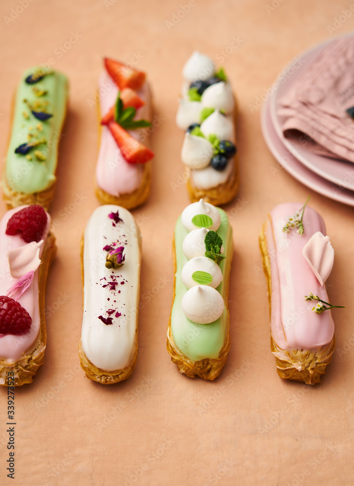 Variety of gourmet eclairs topped with fruit Variety of gourmet eclairs topped with fruit
