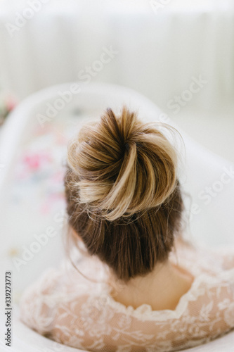 blonde girl with a beautiful hairstyle takes a bath.