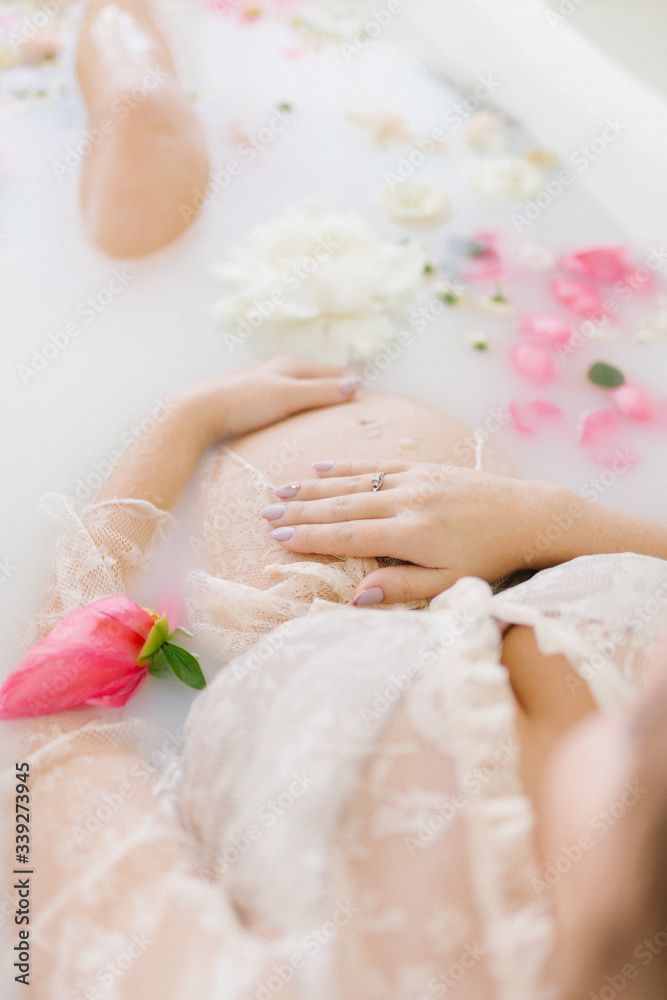 pregnant woman in a bath with flowers pregnant woman in a bath with flowers