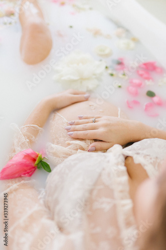 pregnant woman in a bath with flowers