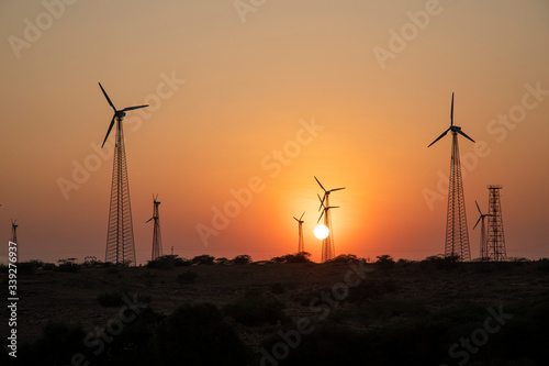 Wind turbines over windmills in Rajasthan, India