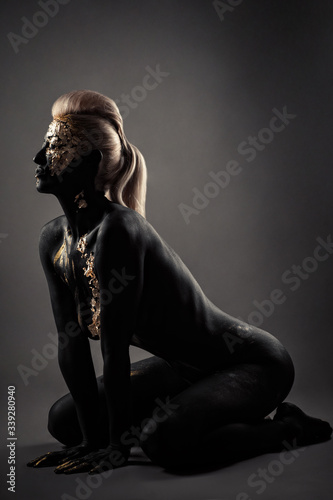 glamour naked blond with black makeup sitting kneeling