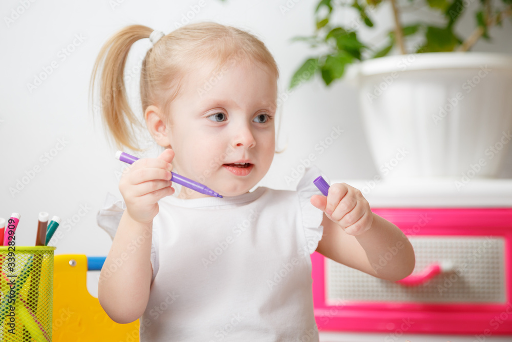Cute Little 3 Years Old Girl In White Shirt And Pony Tails Draw With Markers At Home Cute Little 3 Years Old Girl In White Shirt And Pony Tails Draw With Markers At Home