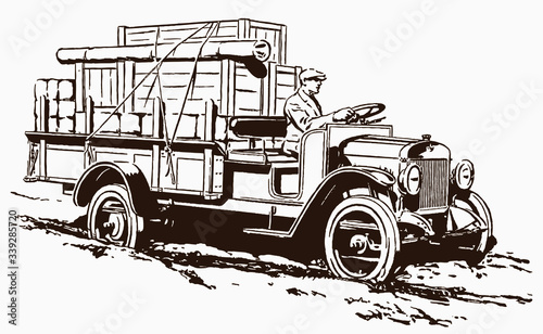 Man from the past transporting boxes and packages with a classic truck on a rough and muddy road. Illustration after an engraving from the early 20th century