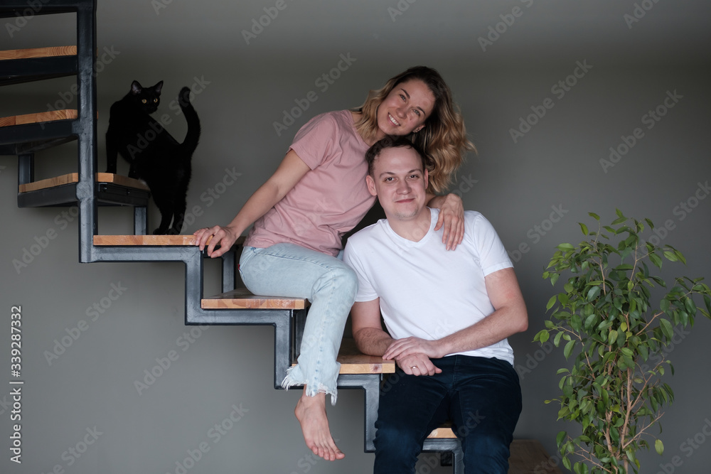 Cheerful smiling couple in love hugging in the bedroom Cheerful smiling couple in love hugging in the bedroom