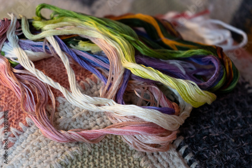 colored threads for embroidery on a hand-knitted plaid, handmade, creativity