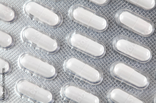 White pills tablets in package. Pharmacy and medicine background.