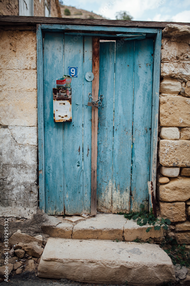 old wooden door with number and mailbox
