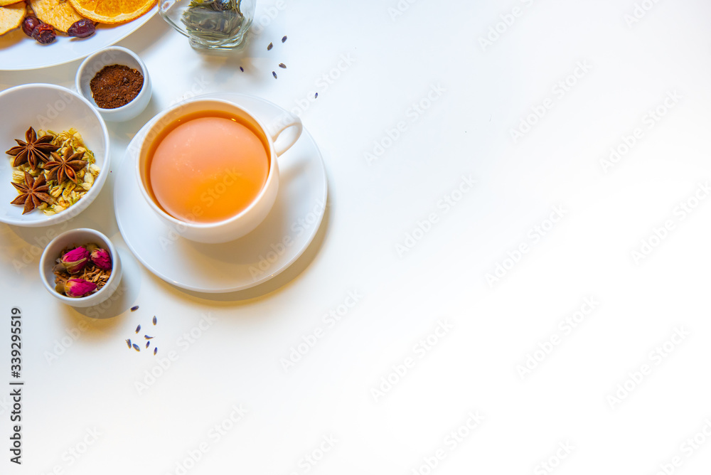 still life of healing herbs and white tea mug on a white background still life of healing herbs and white tea mug on a white background