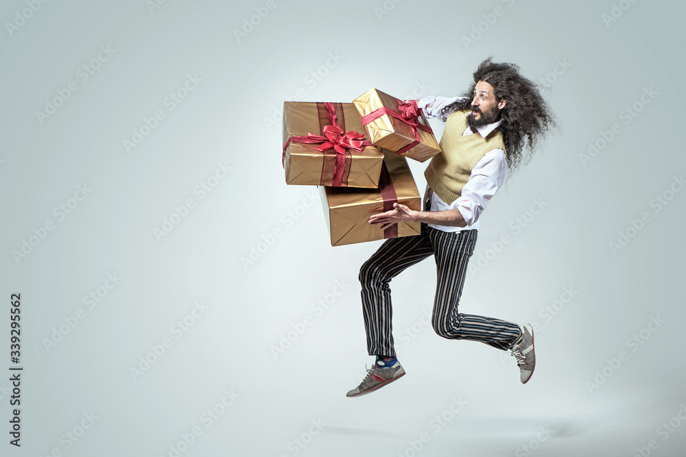 Skinny man running with the bunch of presents Skinny man running with the bunch of presents