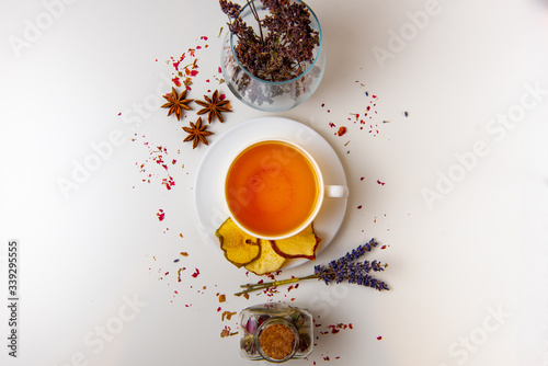 still life of healing herbs and white tea mug on a white background