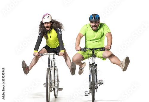Fototapeta Naklejka Na Ścianę i Meble -  Plump and skinny guys riding bicycles