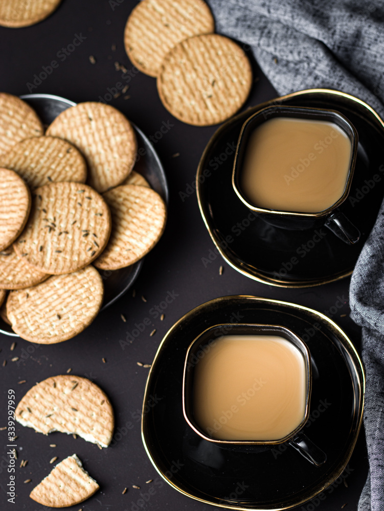 Indian chai in glass cups with metal kettle and other masalas to make the tea Indian chai in glass cups with metal kettle and other masalas to make the tea