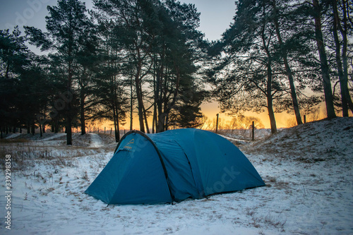 winter camping in the forest, with the dawn © Artem