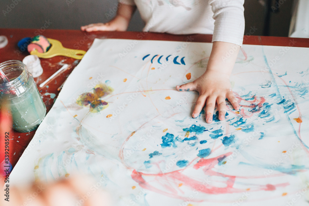 Indoor picture of a child painting with hands Indoor picture of a child painting with hands