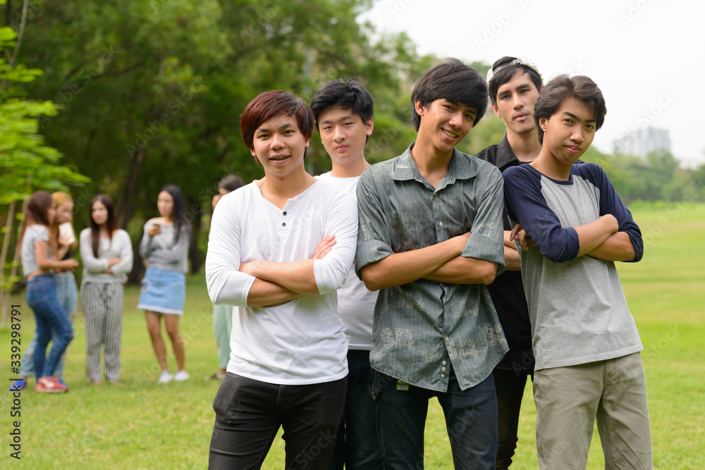 Happy young group of friends hanging out together at the park Happy young group of friends hanging out together at the park