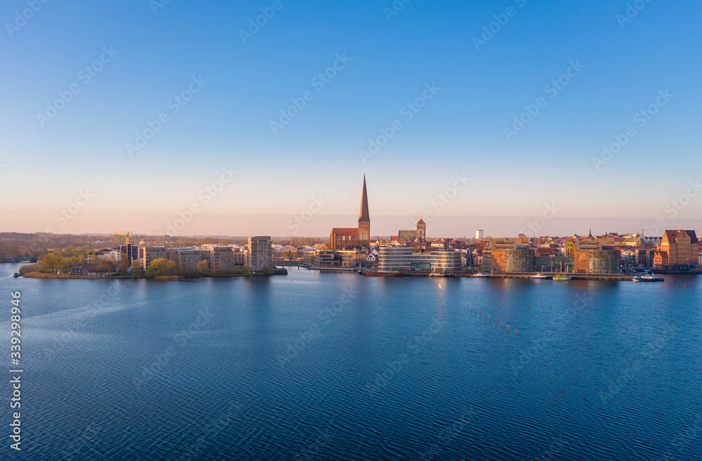 panoramic view of the city of rostock - aerial view over the river warnow, skyline during sunrise in the morning
