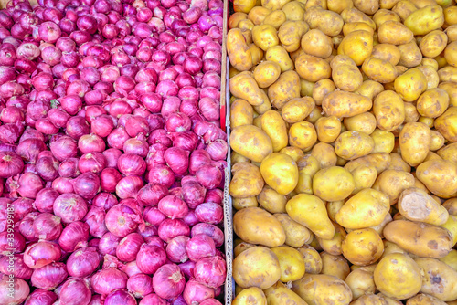 Top view pile of fresh white potatoes and red shallot onions at farmer market in Singapore