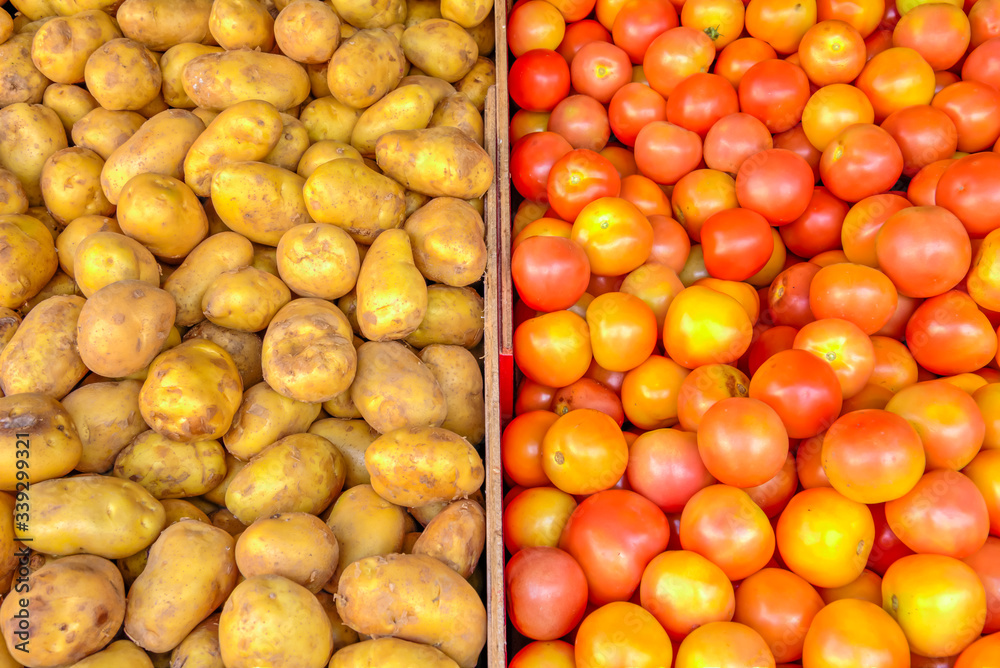 Heap of organic white potatoes and tomatoes at farmer market in Singapore Heap of organic white potatoes and tomatoes at farmer market in Singapore