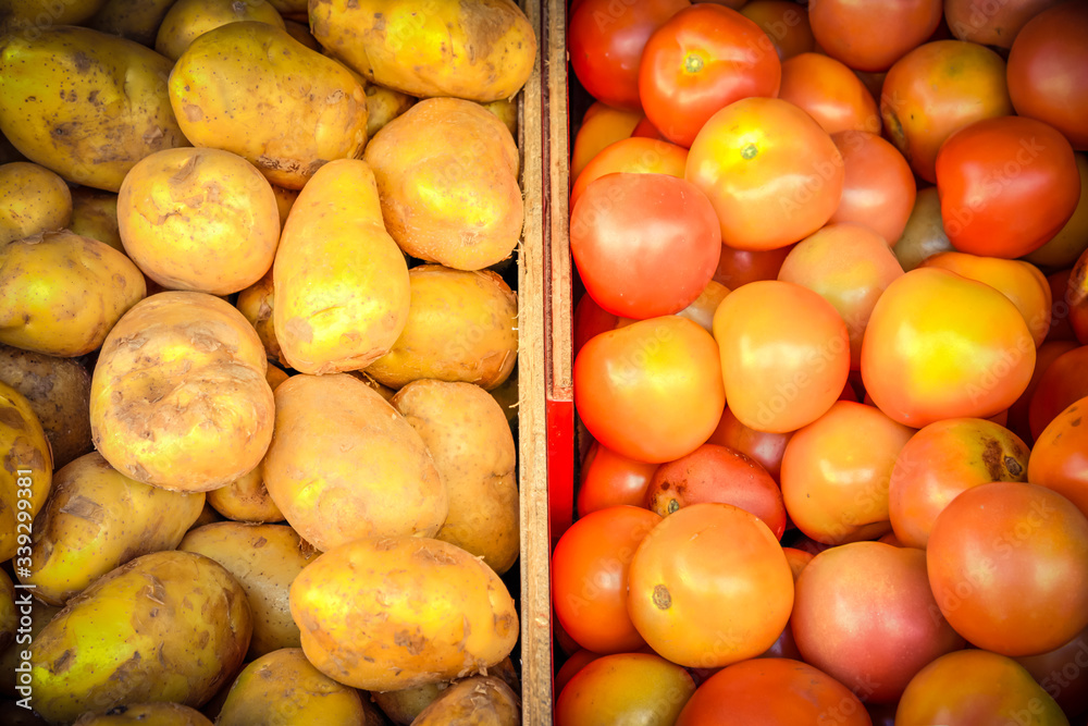 Heap of organic white potatoes and tomatoes at farmer market in Singapore Heap of organic white potatoes and tomatoes at farmer market in Singapore