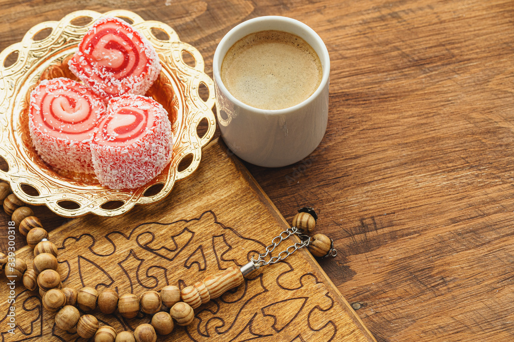 Coffee cup with oriental sweets on wooden table close up