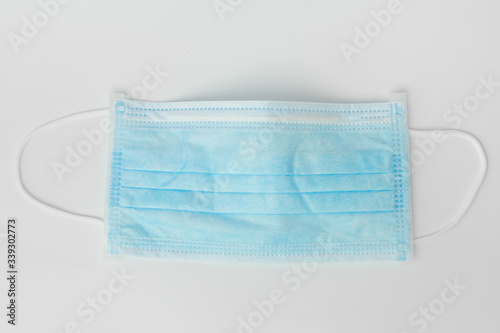 New surgical mask for coronavirus prevention on a white background. Healthcare concept. Medical tools.