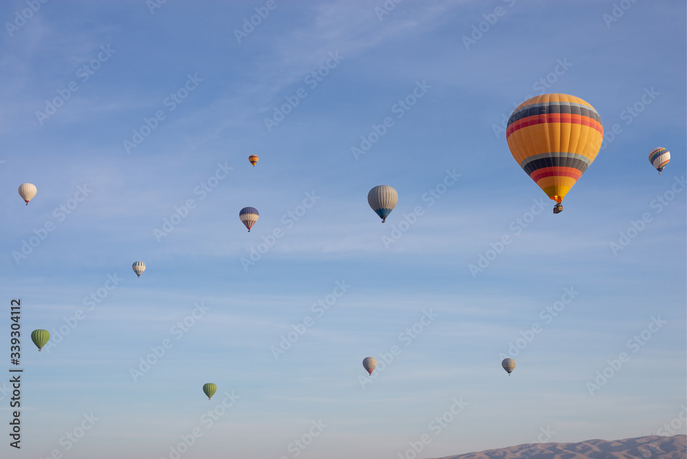 Hot air balloons flying in the blue sky in Goreme Cappadocia. Beautifull background texture. 