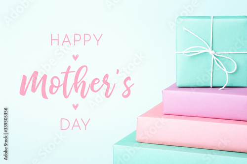 Happy Mother's Day greeting card with pastel colored gift boxes on turquoise ...