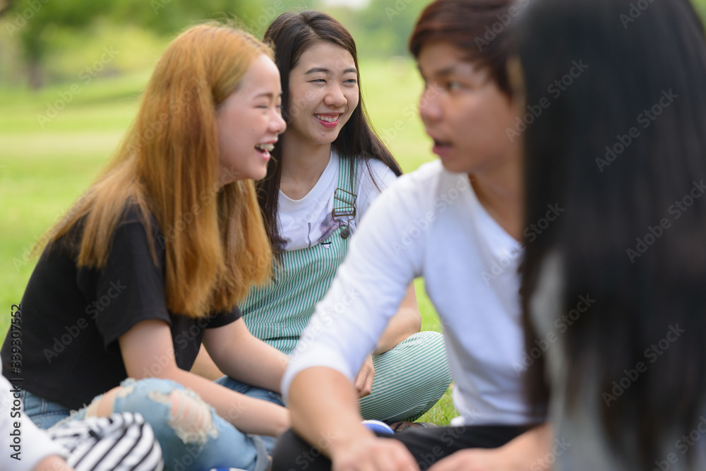 Happy young group of friends having fun together at the park Happy young group of friends having fun together at the park