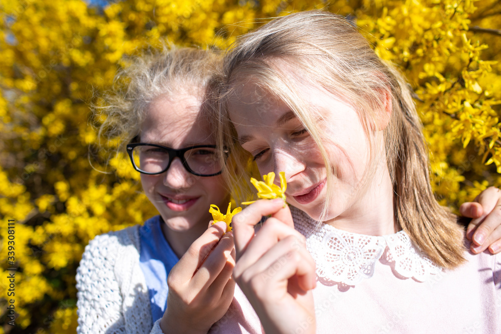 Sisters infront of a spring bush Sisters infront of a spring bush