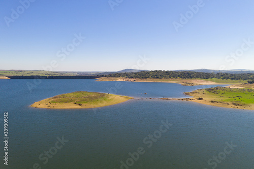 Dam lake reservoir drone aerial view of Barragem do Caia Dam olive trees landscape in Alentejo, Portugal photo