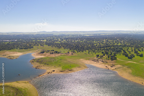 Dam lake reservoir drone aerial view of Barragem do Caia Dam olive trees landscape in Alentejo, Portugal