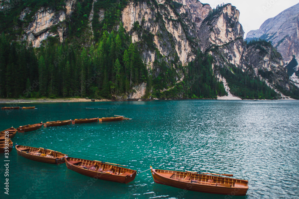 Wooden boats on romantic tourist popular Lago di Braies (Pragser Wildsee) in South Tyrol, Italy