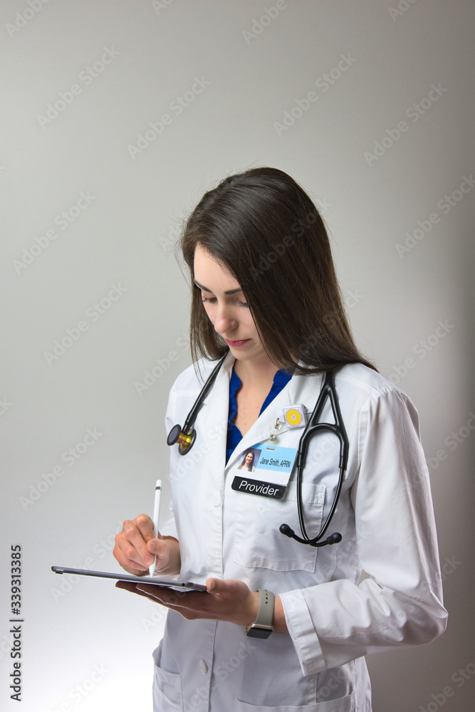 Dark haired woman making note in patient chart. Female healthcare worker with stethoscope making notes Dark haired woman making note in patient chart. Female healthcare worker with stethoscope making notes