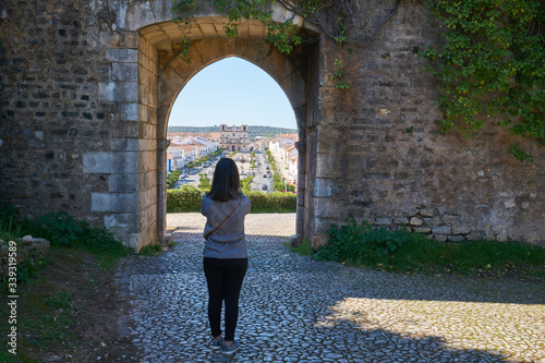 Woman girl traveler photographing Gate Entrance of Vila Vicosa castle in Alentejo, Portugal