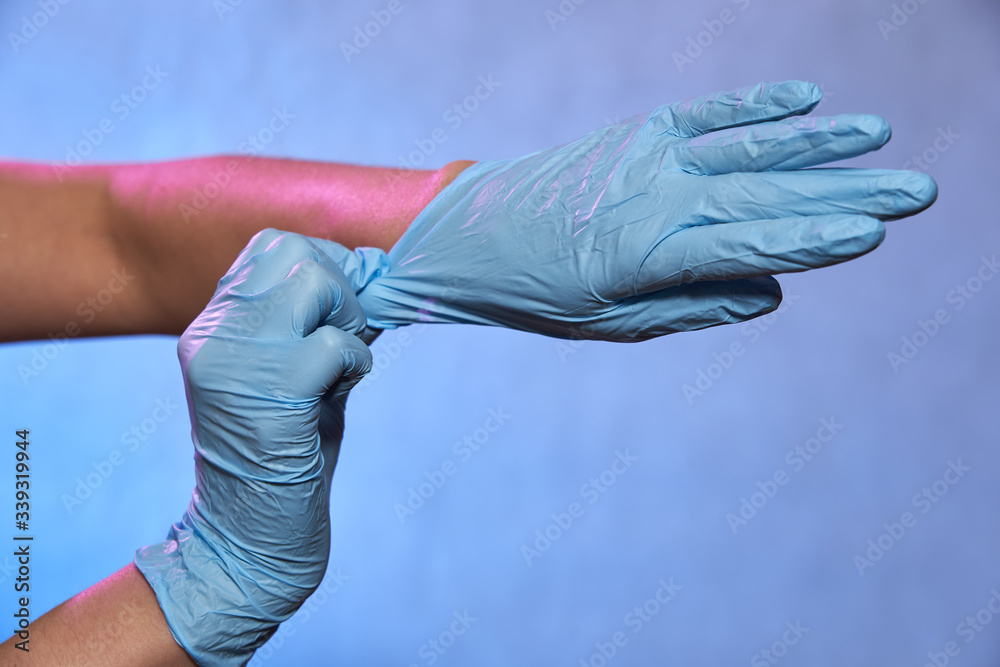 Human hands in blue disposable latex gloves, rubber gloves for hygiene protection from Coronavirus disease COVID-19, surgery and medical exam