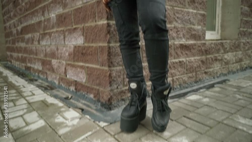 Concept: urban healthcare during pollution pandemic. Beautiful young asian girl with colored hair in medical mask wearing grunge fashion clothing standing street