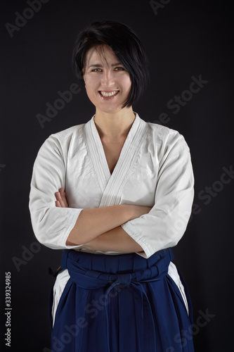 Portrait aikido master woman wearing traditional samurai hakama clothes. Isolated on black Background photo