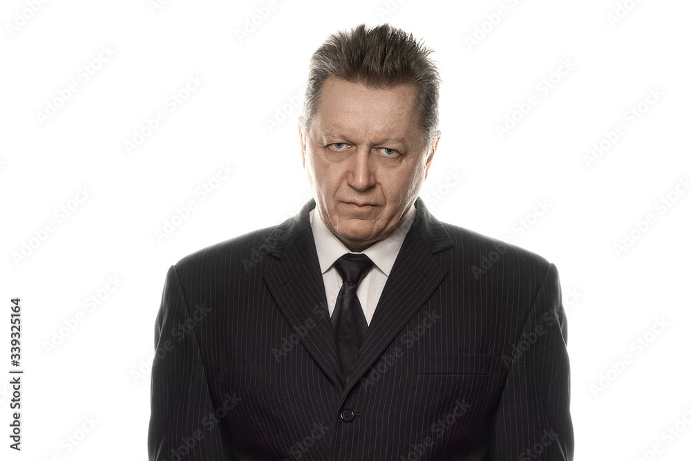 Portrait of an old strong frowning man in black suit solated in a white background. big brother watching concept Portrait of an old strong frowning man in black suit solated in a white background. big brother watching concept