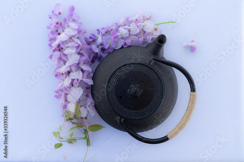 Japanese teapot with purple flowers on a white background