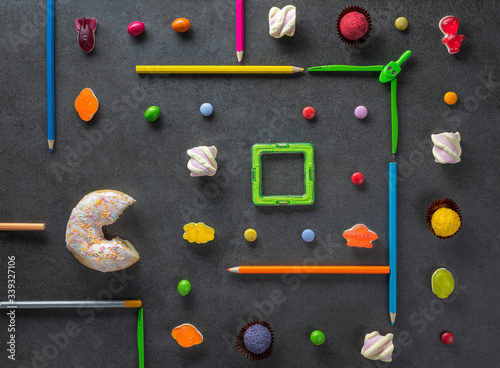 overhead view to white donut that eats jelly sweets in maze like in Pac Man computer game