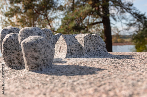 Small granite stone monument with houses