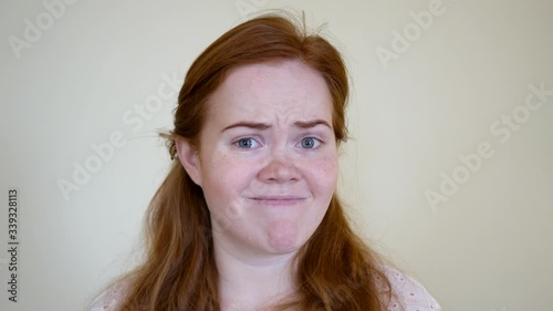 woman in an isolated, homogenous background upset and angry about bad situation