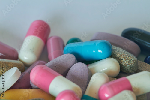 Concept of treatment, options for forms of pharmacological preparations, backdrop of multicolored medicine pills and capsules.