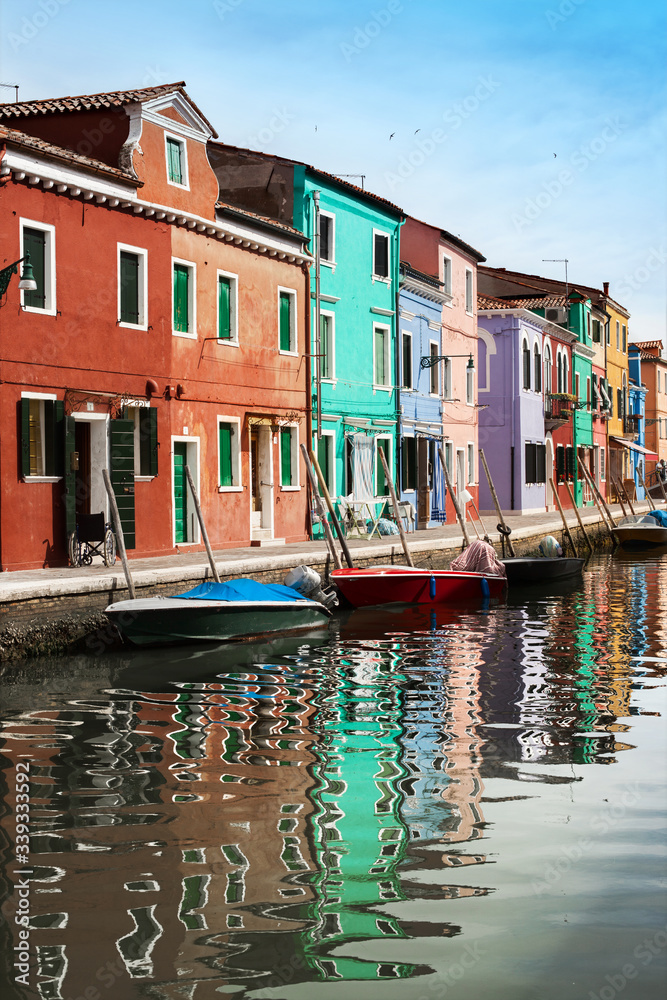 Colorful houses of Burano and boats in the water