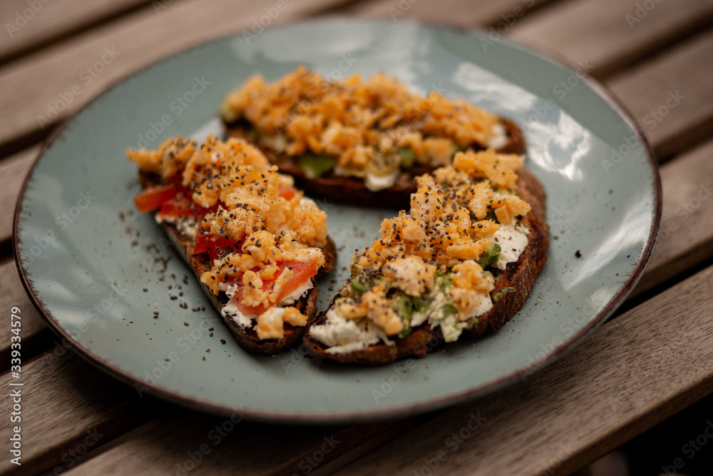 Avocado toasts with scrambled eggs, feta cheese and tomatoes Avocado toasts with scrambled eggs, feta cheese and tomatoes