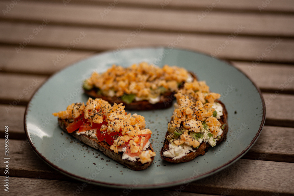 Avocado toasts with scrambled eggs, feta cheese and tomatoes Avocado toasts with scrambled eggs, feta cheese and tomatoes