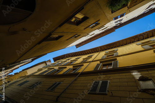 Narrow street view from the bottom up to the sky