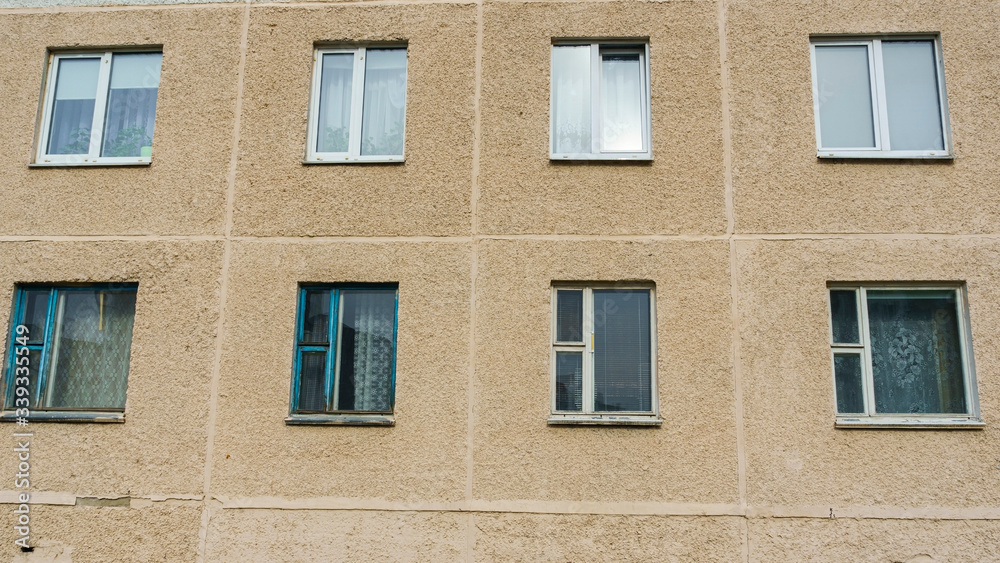 View of the panel wall with windows of the Soviet house. Slum concept.
